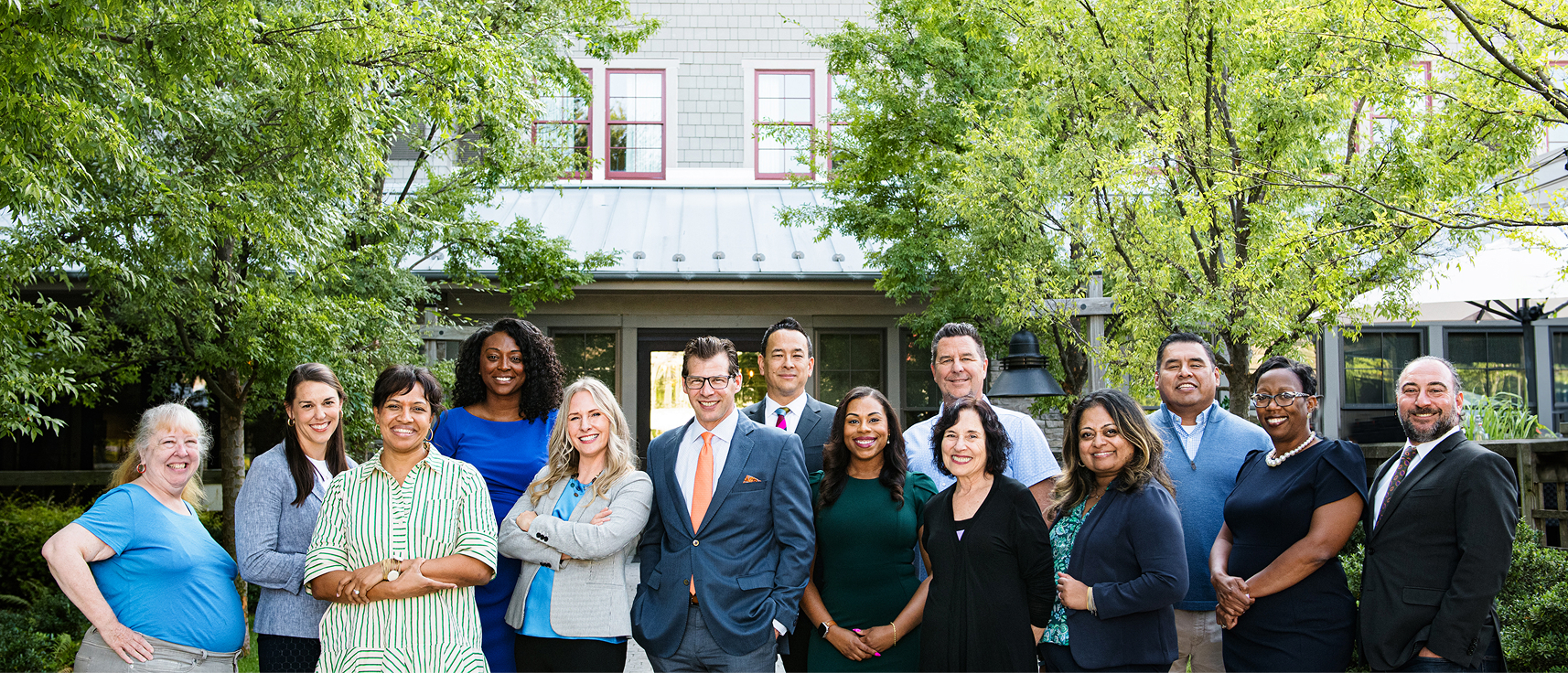 14 people outdoors in front of a building
