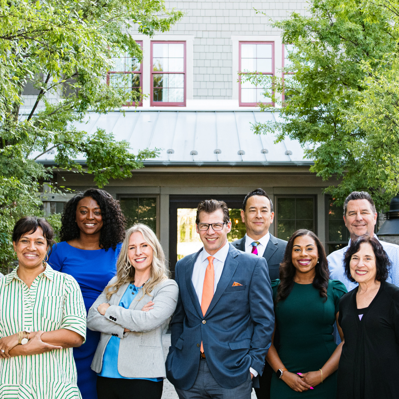 8 people outdoors in front of a building